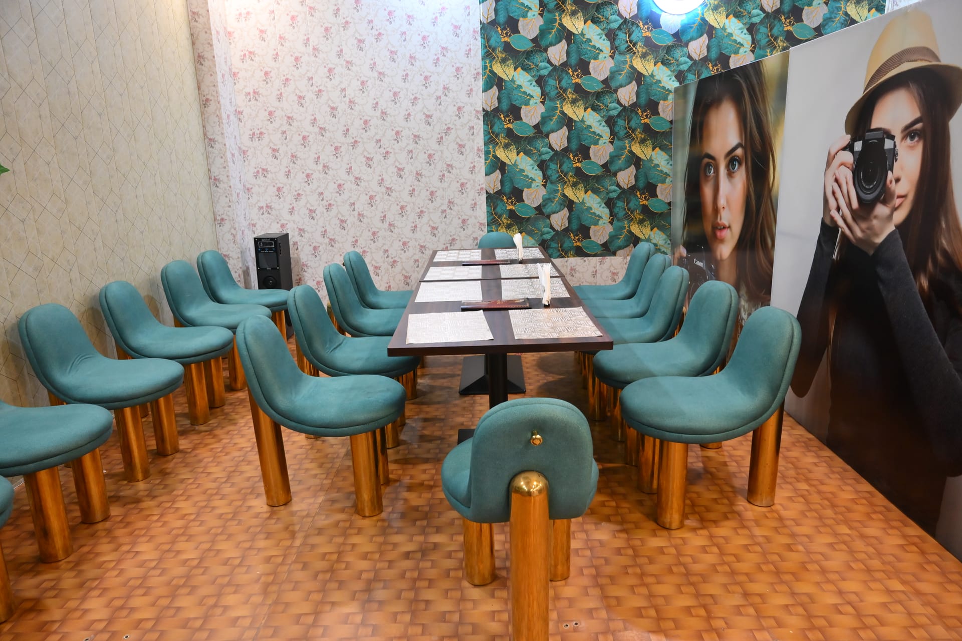 The La Gardenia dining room with teal chairs and patterned walls